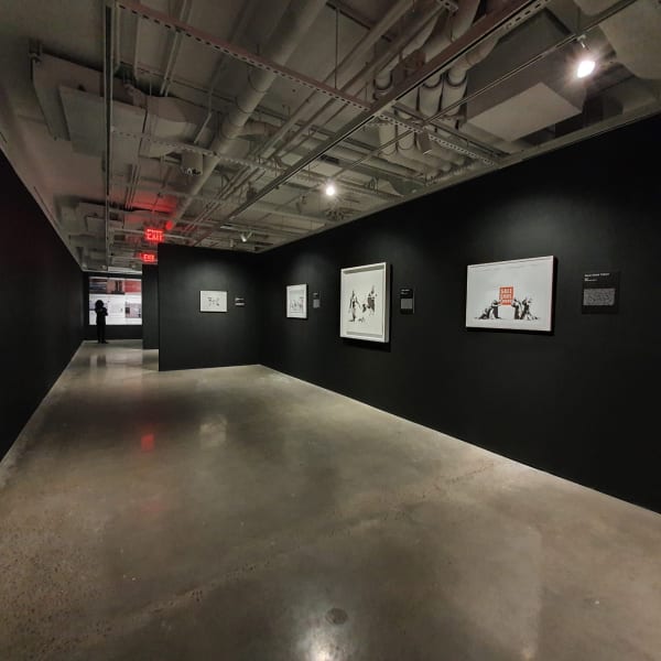 Banksy artworks hanging on wall