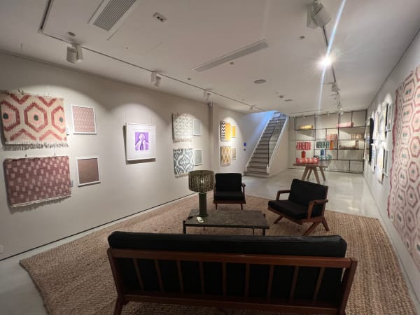 Exhibition view from the downstairs of Andipa Gallery. Artwork and tapestries hanging on the walls.