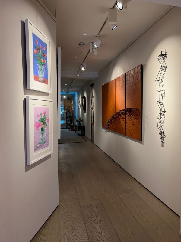 Exhibition view from the downstairs of Andipa Gallery. Artwork and tapestries hanging on the walls.