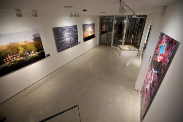 Slinkachu prints hanging in exhibition at andipa gallery.