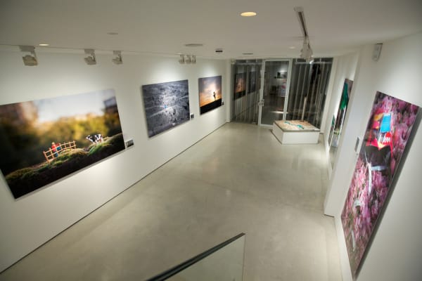 Slinkachu prints hanging in exhibition at andipa gallery.