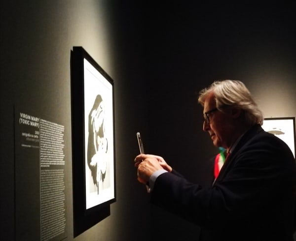 Guest taking photo at the exhibition opening