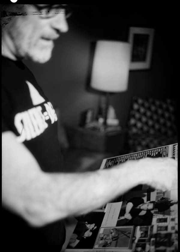 Ian Lewandowski Billy pointing to a snapshot of himself in the mid-1980s that he included in a commemorative collage for his brother, David, former member of The Saint, who died of AIDS-related complications in 1996 at the age of 37, Chelsea, Manhattan., 2024 Gelatin silver contact print 10 x 8 inches 1/2 (ed of 2 and 1 AP)