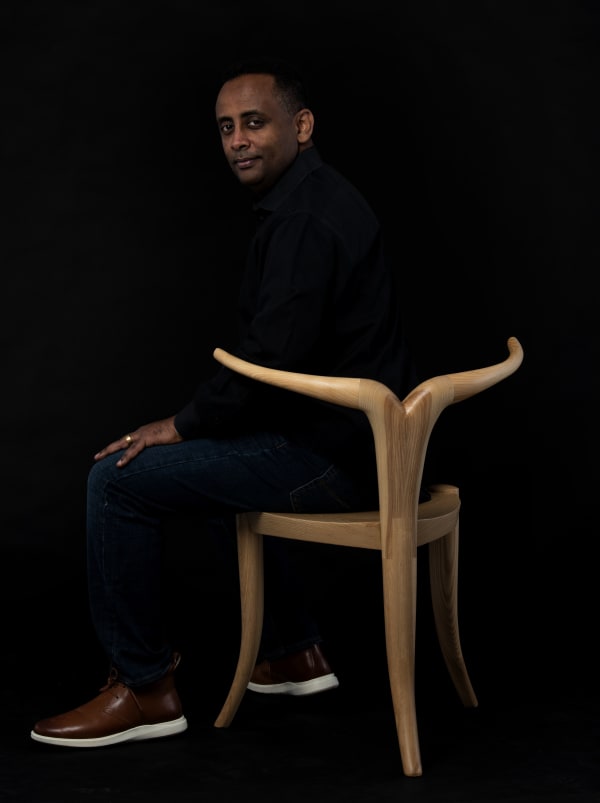 Jomo Tariku sitting on a Nyala Chair ©Gediyon Kifle
