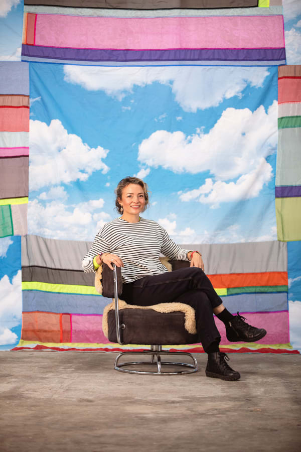 artist seated in front of her textile