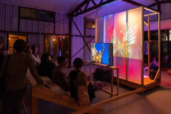 people seated viewing a video by Trey Burns