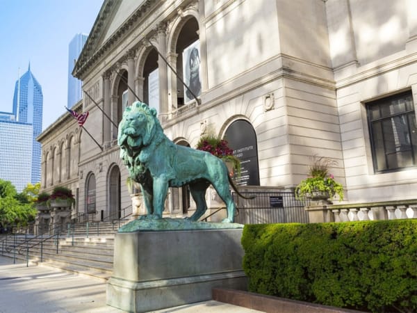 a building with a green lion statue in front.