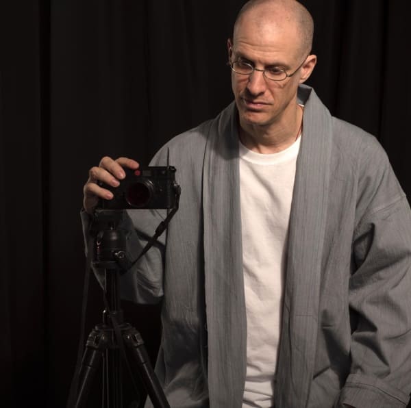 Frontal portrait of Michael Cherney with his camera