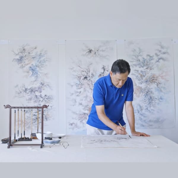 Portrait of artist Arnold Chang working on his painting