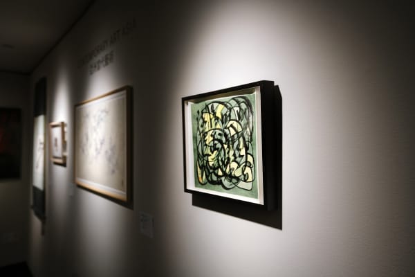 gallery wall with lit up art.