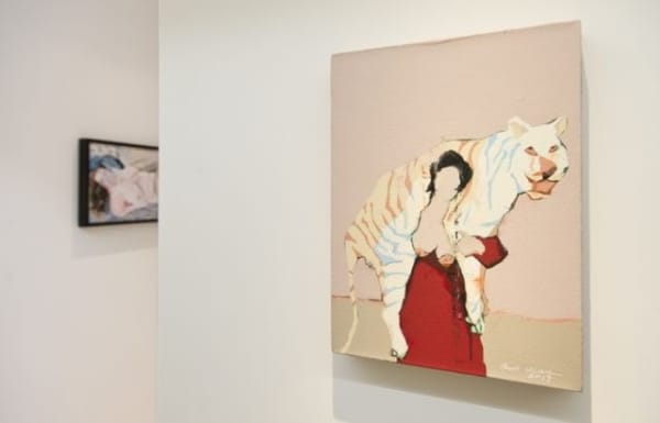 fu qiumeng gallery space with a painting of a woman with a tiger on her shoulders.