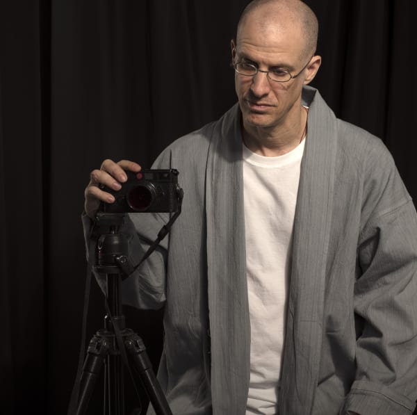michael cherney standing next to his camera