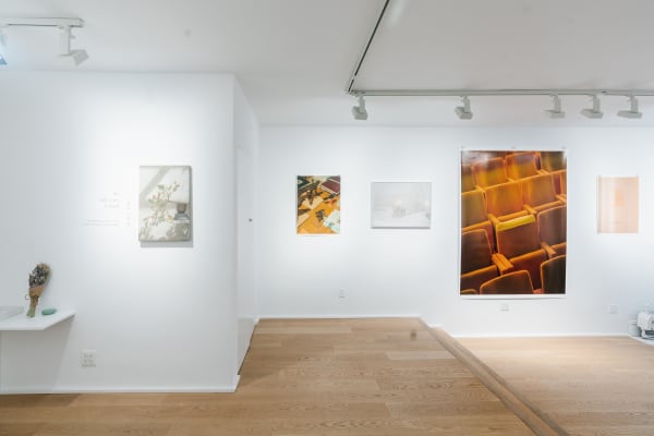 Photography exhibition display with walls of varying sizes of photographic works