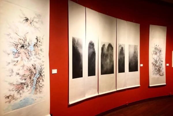 A group of scroll hanging on a red wall