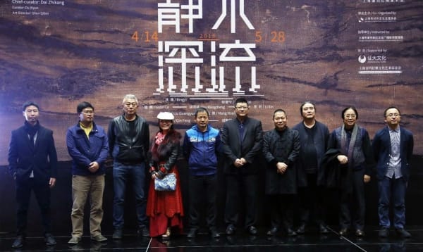 A group of people standing in front of a banner