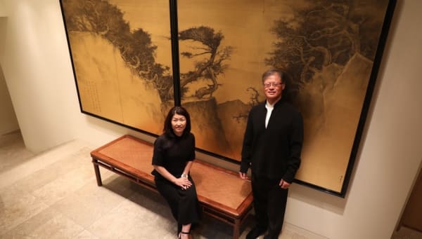 Akiko Yamazaki  was sitting on the left and Jerry Yang standing on the right side, a screen behind them