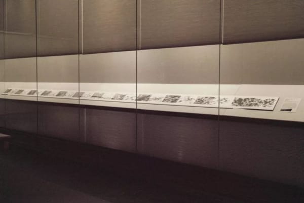 The album is unfolded and displayed in the museum's showcase
