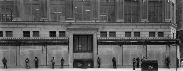 Fifth Avenue saks department store, the doors and windows were boarded up and a line of people were standing outside