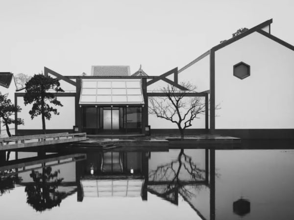 A building with a body of water has reflection