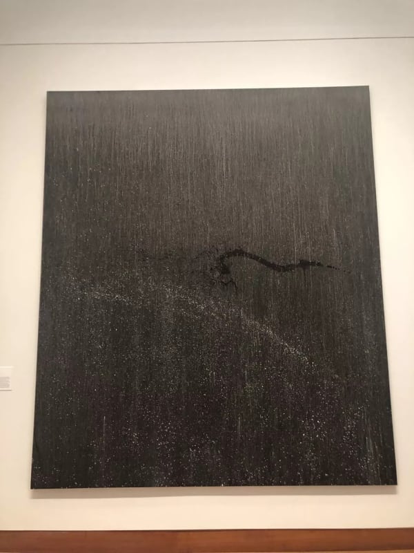 black painting hanging on the wall