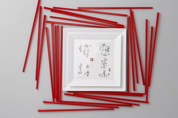 A white plate with red sticks around it