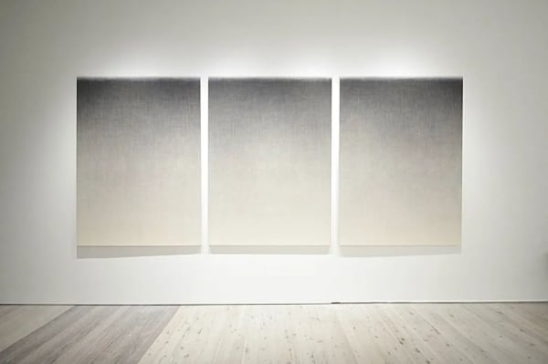 Grey and white gradient triptychs hanging on the wall