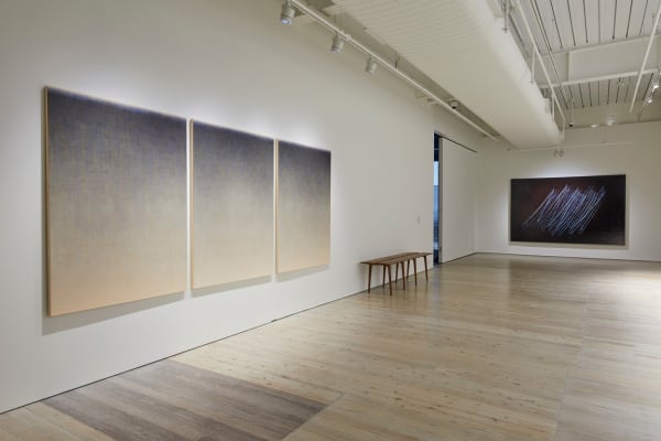 Grey and white gradient triptychs hanging on the wall