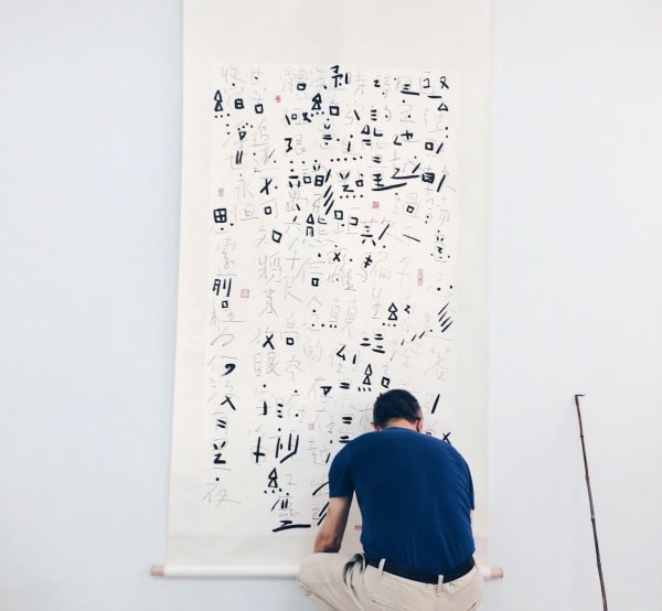 Fung Ming Chip is placing his scroll