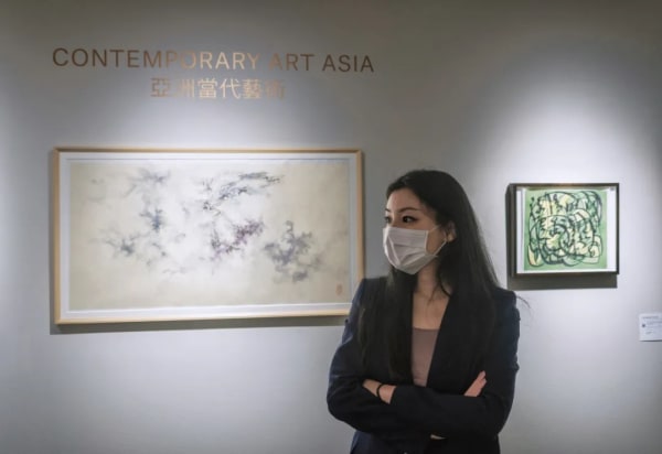 qiumeng in front of the contemporary art asia exhibition entrance. 