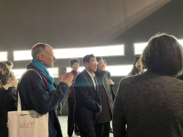 Visitors gathering and talking about artworks