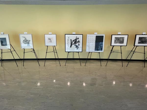 seven artworks exhibiting on tripod stands