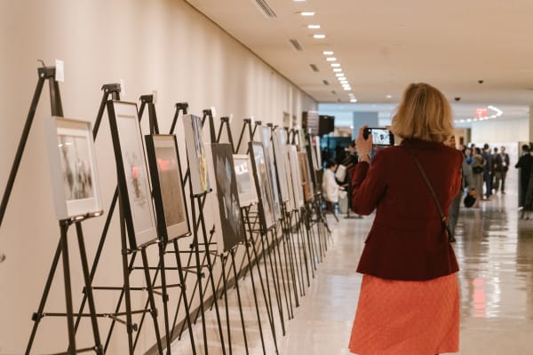 A person taking a picture of a Exhibition