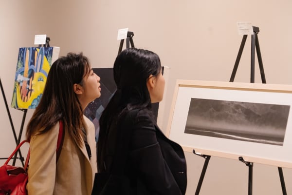 A couple of women looking at a picture