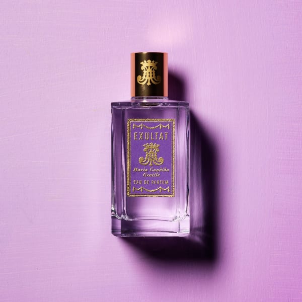Perfume bottle EXULTAT by Maria Candida Gentile against a purple background