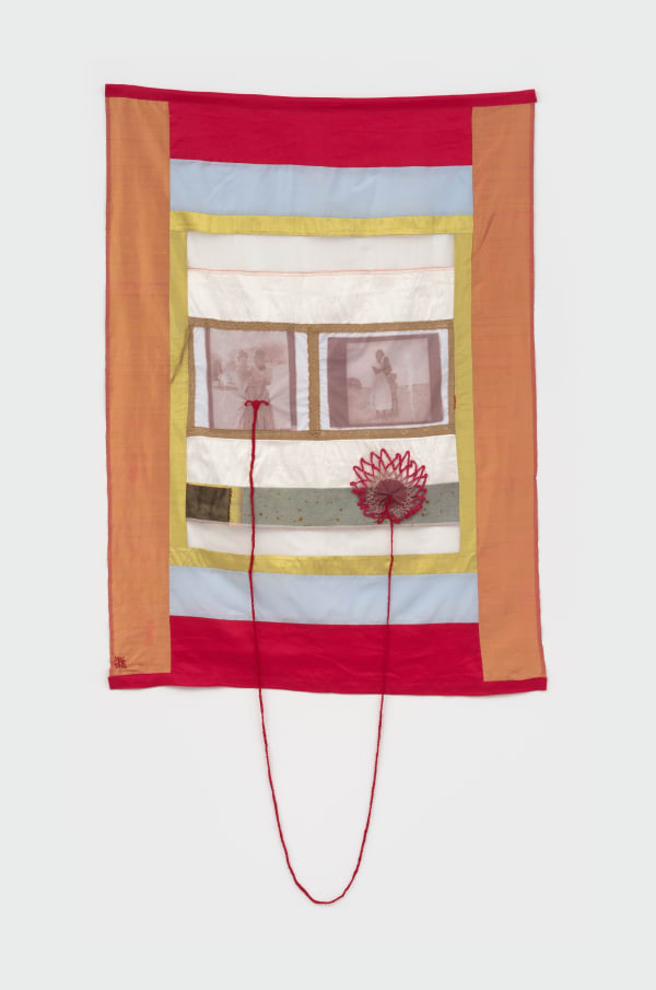 Handmade tapestry with colorful fabric. This work depicts archival image transfer from South Namibian archival images. Red embroidery string connects to part of the tapestry.