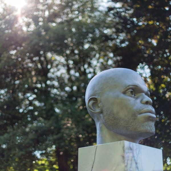Installation view of Thomas J Price Numen, (Shifting Votive Two), 2016, Aluminium and marble, Overall: 182 x 57 x 63 cm, 71 5/8 x 22 1/2 x 24 3/4 in, Head: 72 x 57 x 63 cm, 28 3/8 x 22 1/2 x 24 3/4 in, Plinth: 110 x 50 x 50 cm, 43 1/4 x 19 3/4 x 19 3/4 in