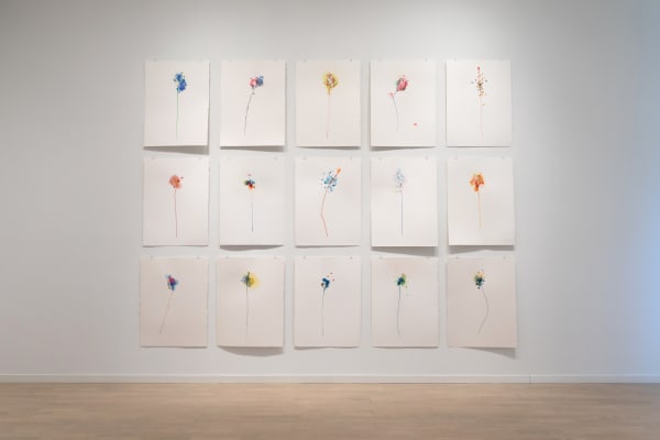 Fifteen Gustavo Bonevardi floral paintings on paper, arranged three by five.