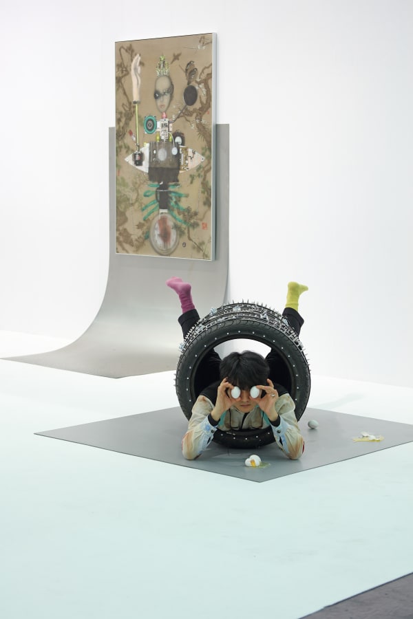Tong Kunniao 童昆鸟, Eggs Under the Four Tiles 四条轮胎下的鸡蛋, 2022, installation with performance, tiles, leather, rivets, variable size. Courtesy of the artist and Hua International. Booth Designed by Krista Xueying Yu.