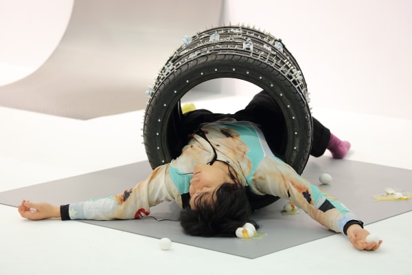 Tong Kunniao 童昆鸟, Eggs Under the Four Tiles 四条轮胎下的鸡蛋, 2022, installation with performance, tiles, leather, rivets, variable size. Courtesy of the artist and Hua International. Booth Designed by Krista Xueying Yu.