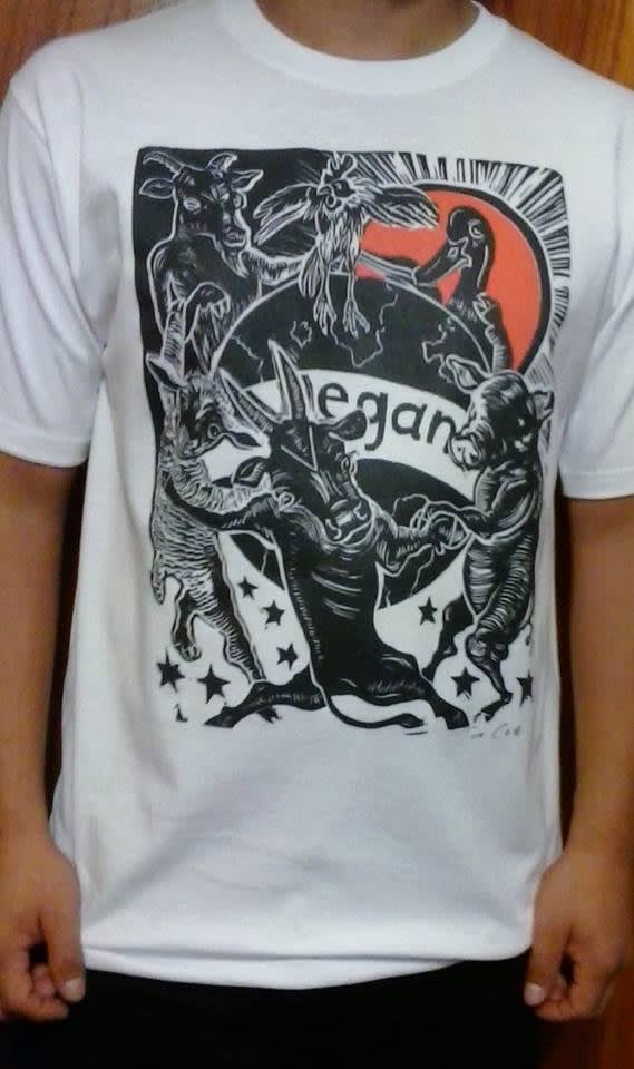 Photograph of a man wearing a T-Shirt with an image of Sue Coe's "Animals Around a Vegan World" printed on it, Mexico City, Jan 2016