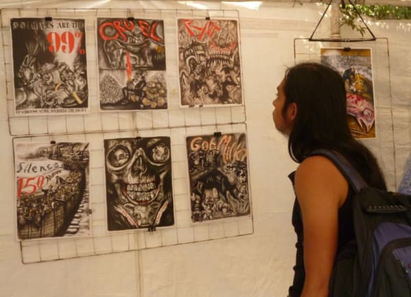 Photograph of a person looking at the installation reproductions of the artist's artwork at the Tiempo Animal Exhibition, Mexico City, 2018 