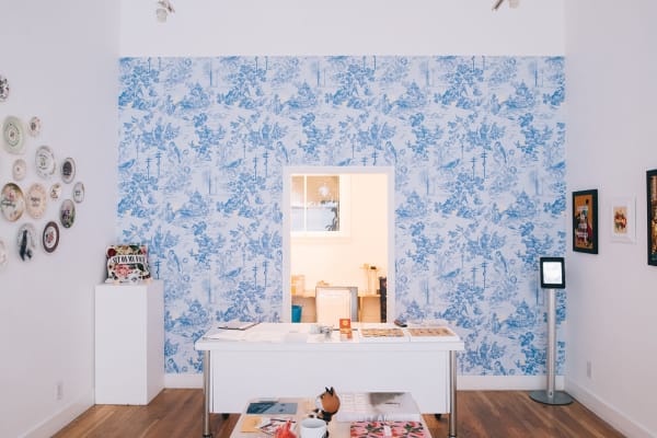 Install shot of decorative plates hung on a wall as part of MC Marquis exhibition