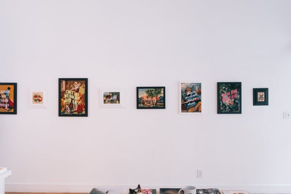 Install shot of embroidered artworks by MC Marquis