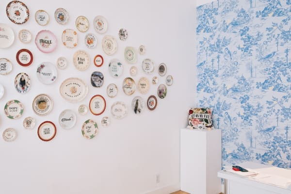 Install shot of decorative plates hung on a wall as part of MC Marquis exhibition