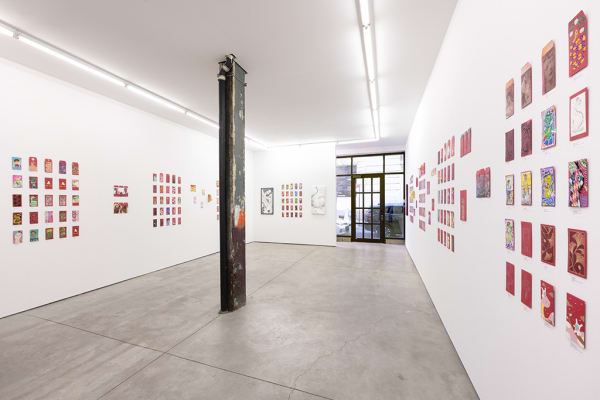 installation photograph of lunar new year red envelopes hung on a white wall 