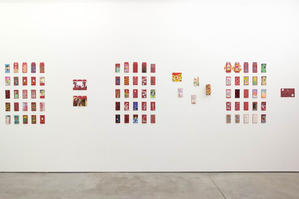installation photograph of lunar new year red envelopes hung on a white wall 