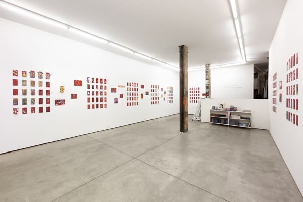 installation photograph of lunar new year red envelopes hung on a white wall 