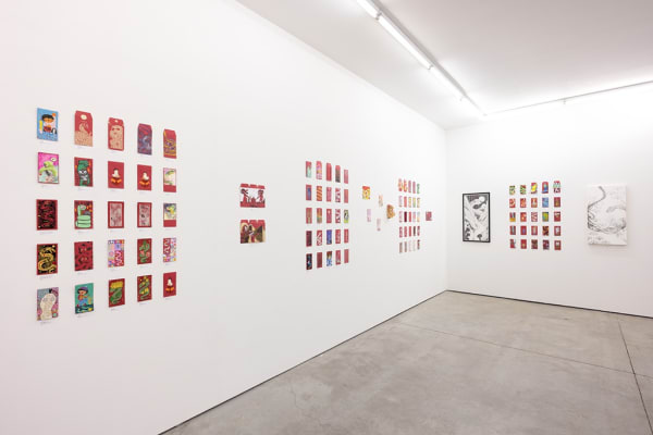 installation photograph of lunar new year red envelopes hung on a white wall 