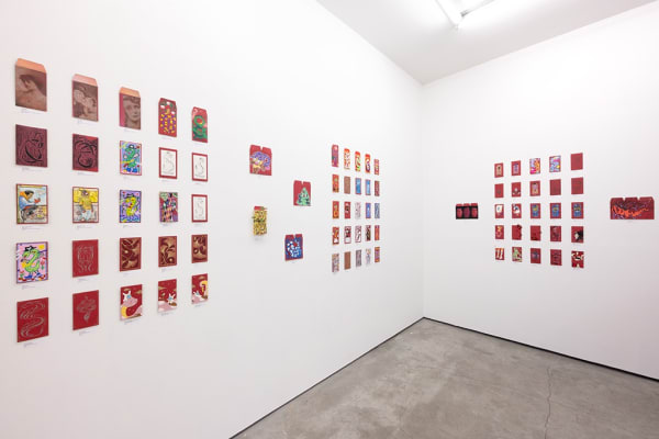 installation photograph of lunar new year red envelopes hung on a white wall 