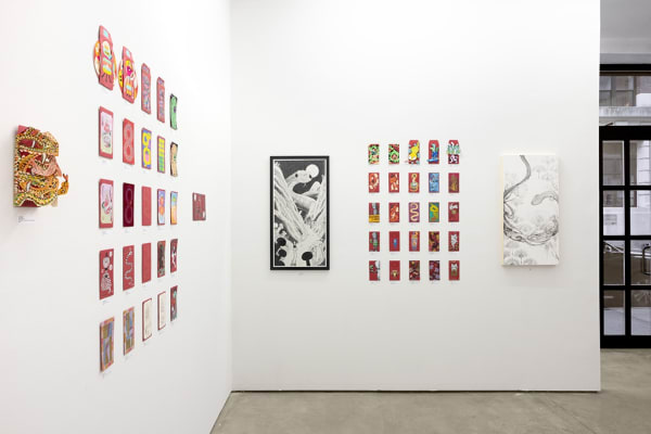installation photograph of lunar new year red envelopes hung on a white wall 